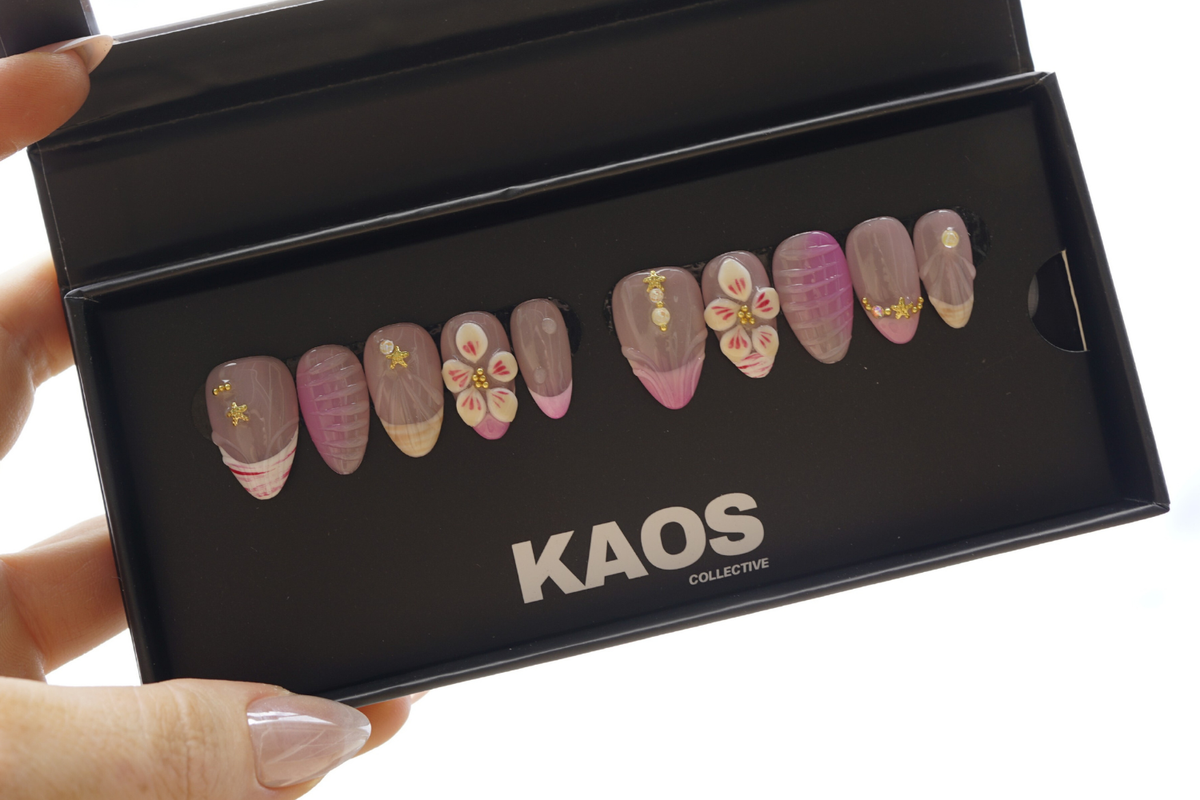 Nail art display with 'KAOS Collective' branding