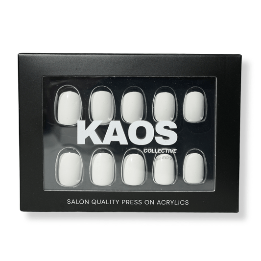 Box of white press-on acrylic nails with 'KAOS Collective' branding on a white background