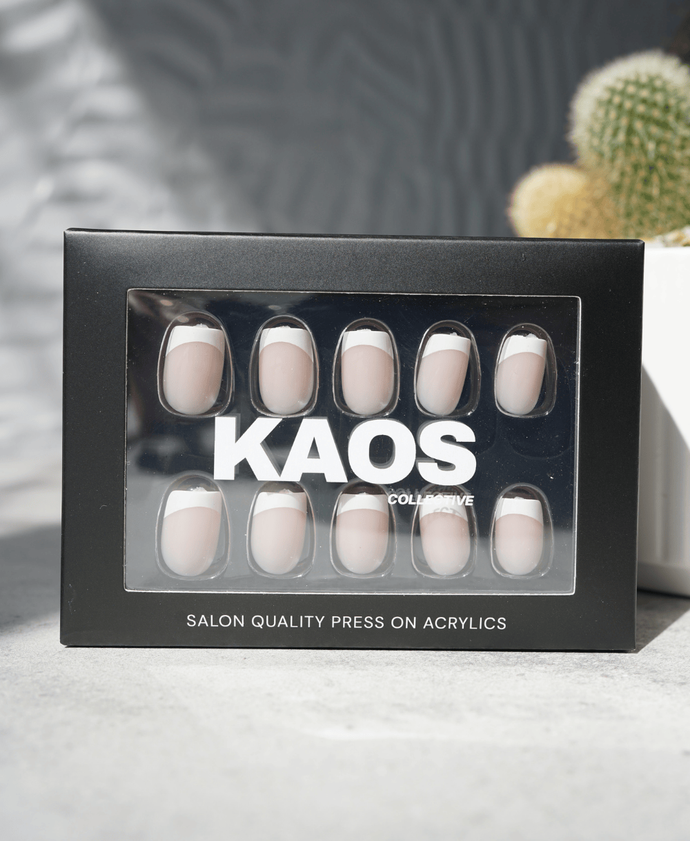 Box of press-on acrylic nails with 'KAOS' branding on a neutral background