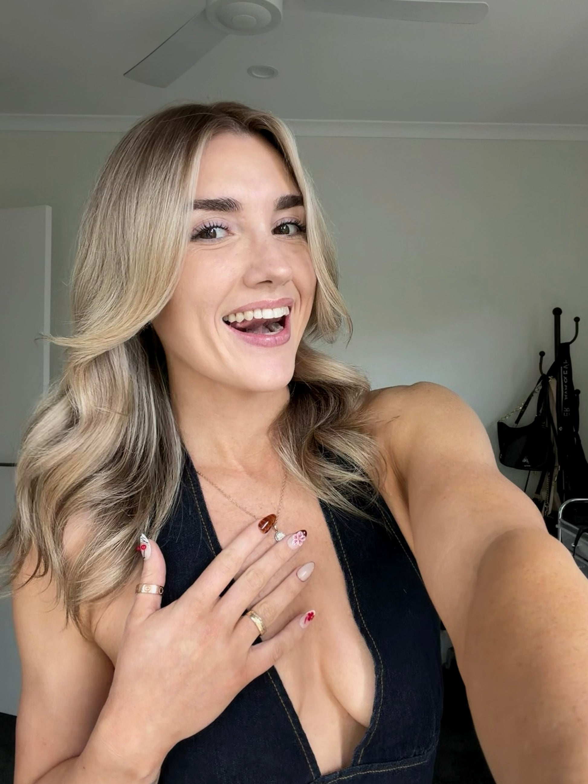 A woman wearing designed press on nails with blonder hair