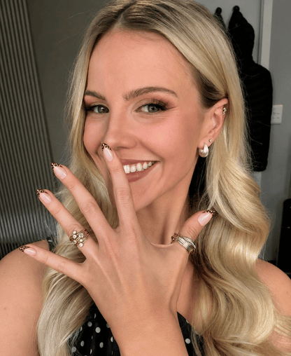 A girl with blonde hair showing her polkadot press on nails