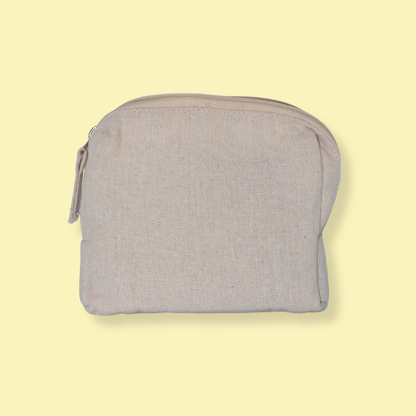 A light gray linen zippered pouch with a matching zipper pull, shown against a solid pale yellow background.