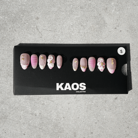 Box of decorative nails with 'KAOS Collective' branding on a gray background