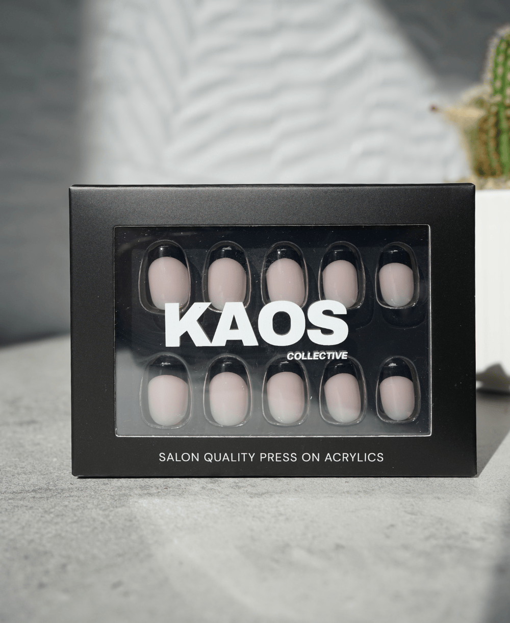 Box of press-on acrylic nails with 'KAOS Collective' branding on a neutral background.