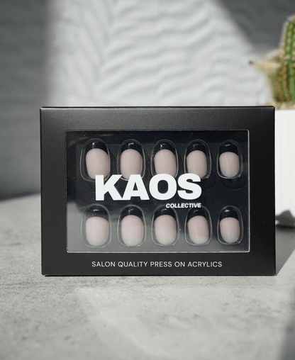 Box of press-on acrylic nails with 'KAOS Collective' branding on a neutral background.
