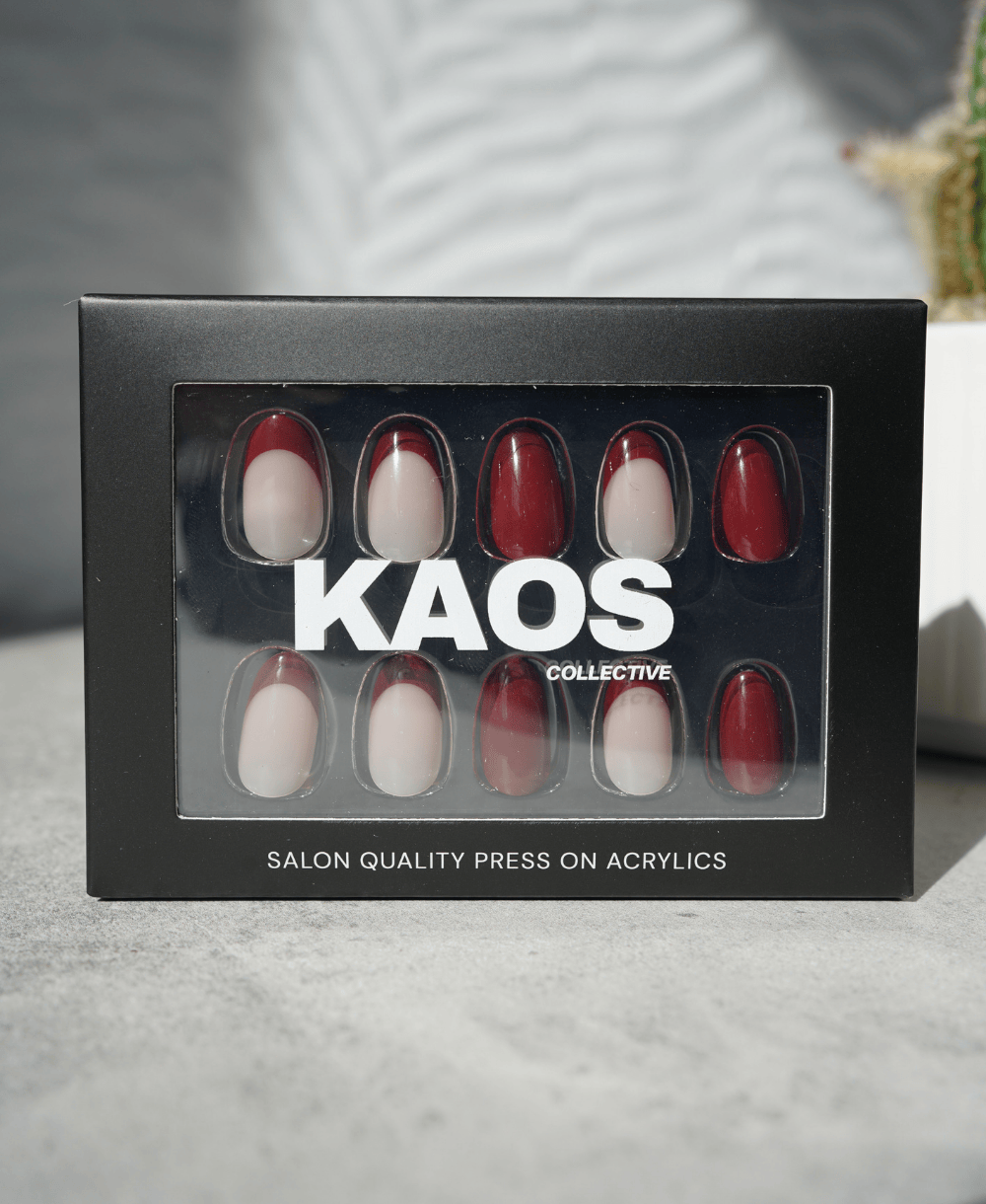 Box of 'KAOS Collective' press-on acrylic nails on a neutral background