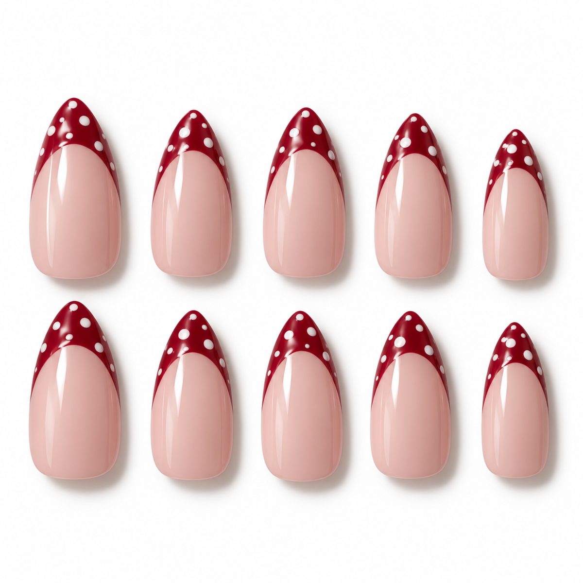 Ten false almond-shaped nails arranged in two rows on a white background, featuring a glossy pale pink lower section and a deep red pointed tip with white polka dots.