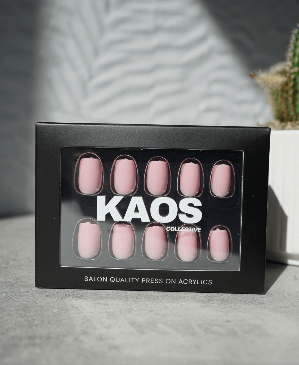 Box of press-on acrylic nails with 'KAOS Collective' branding on a neutral background.