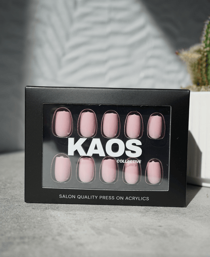 Box of press-on acrylic nails with 'KAOS Collective' branding on a neutral background.