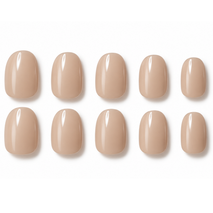 Ten nude beige press-on nails arranged in two rows of five on a clean white background.