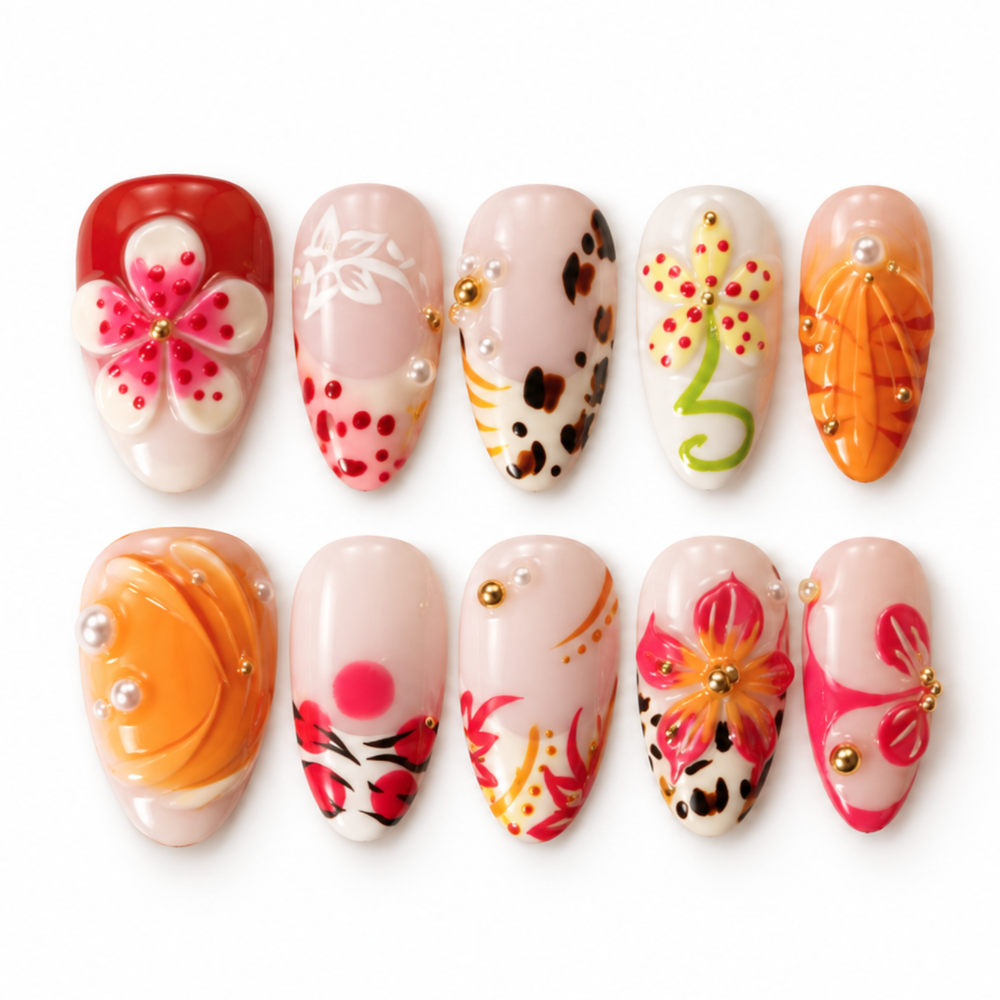 Ten decorative false press-on nails arranged in two rows on a white background. Each nail has a glossy pastel base with colorful floral, leaf, or abstract hand-painted details and small pearl accents.