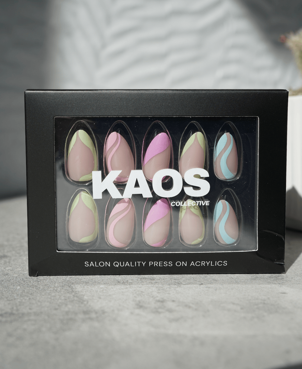 a black box with 'Kaos Collective' on a neutral background